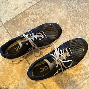 On Cloud running shoes. No visible stains or tears.   Black/sandstone.